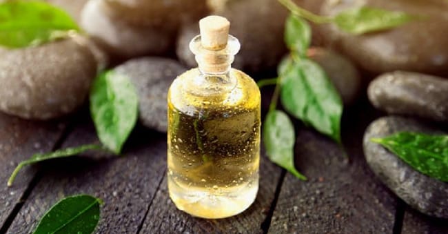 Tea tree oil bottle used to soothe eczema-related skin irritation